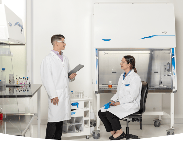 Lab professional performing precise bench work in a controlled laboratory environment